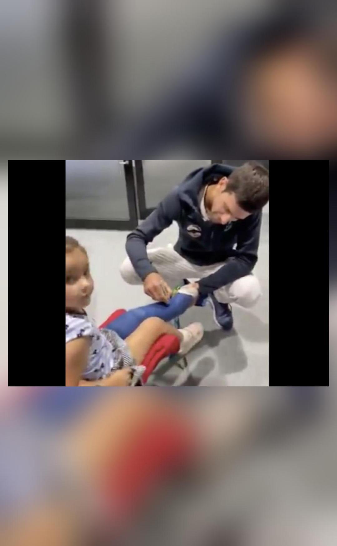 Video shows Djokovic drawing 'duck' for young fan with broken leg