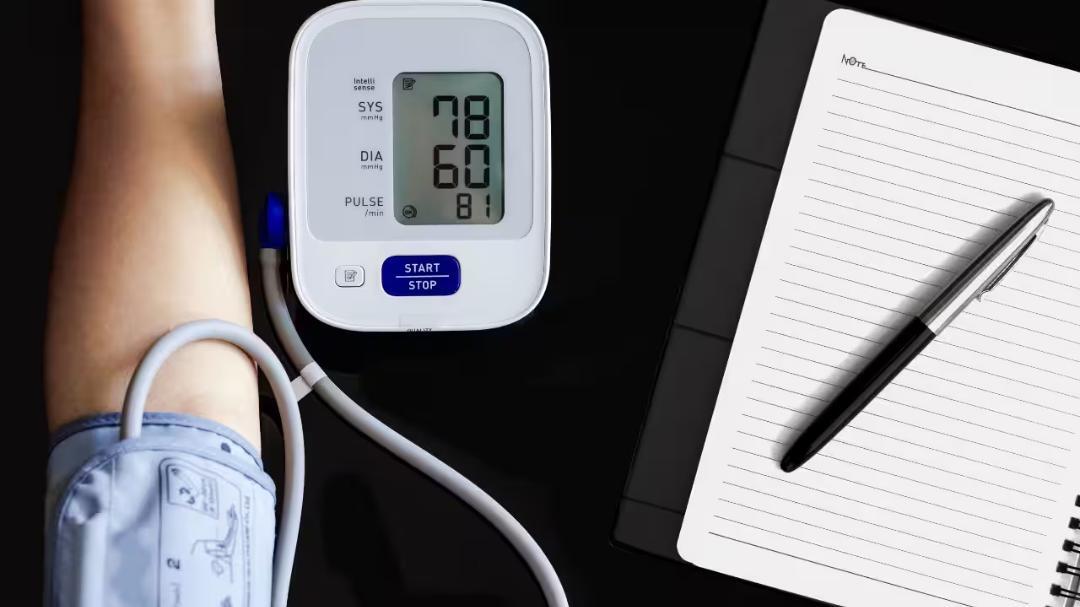 Why does blood pressure fall after a person stands up?