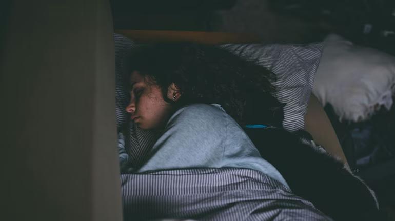 Why did humans stop sleeping twice every night?